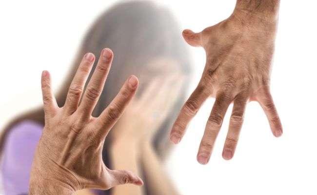 Two hands showing violence on a woman